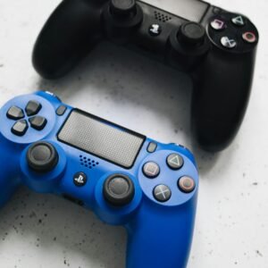 Close-up of black and blue PlayStation controllers. Perfect for gaming enthusiasts.